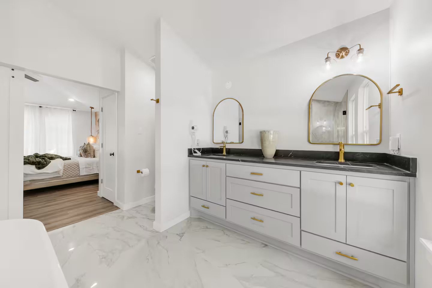 Bathroom 2 - Double vanity with gold fixtures and marble floor