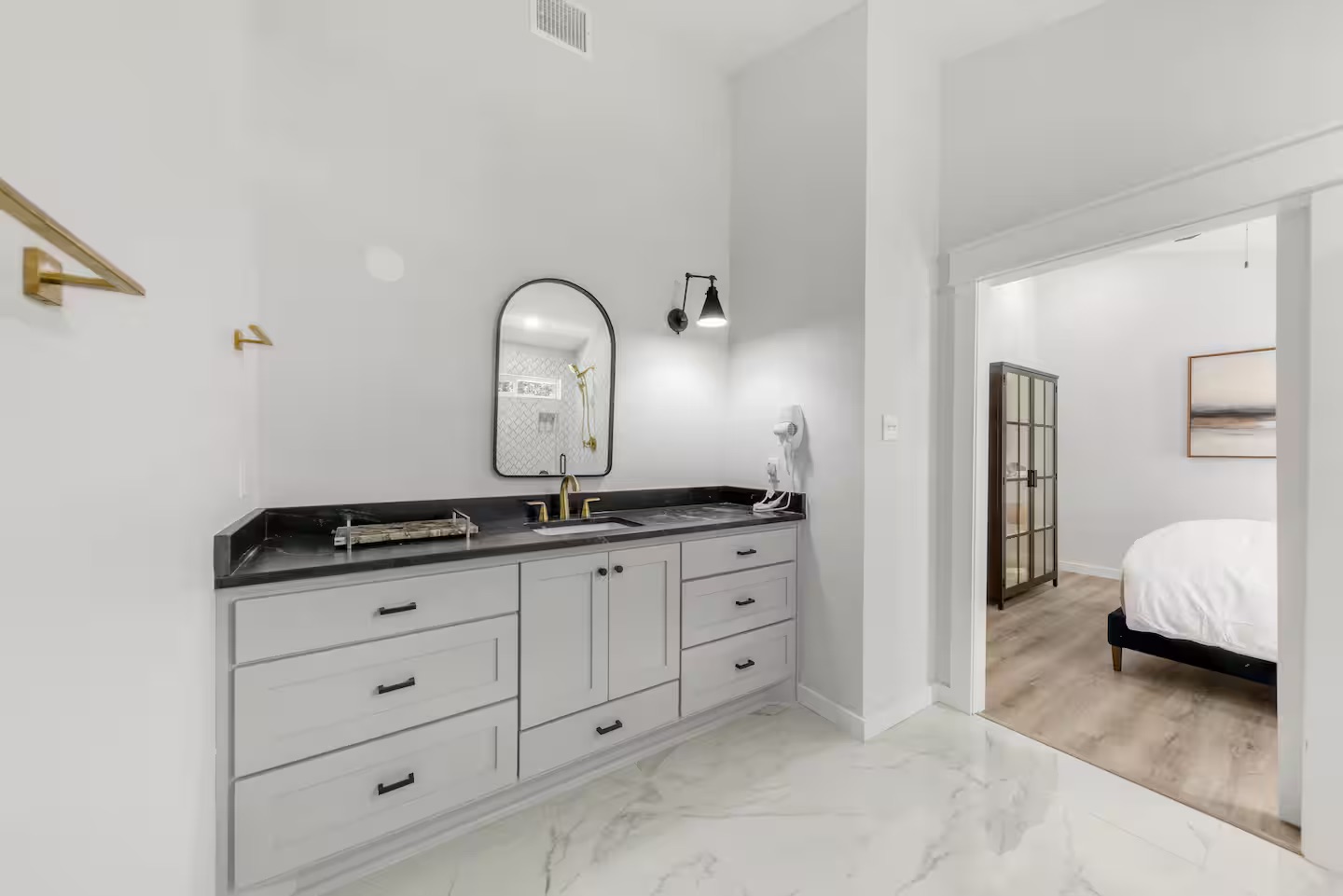 Bathroom 5 - Vanity with arched mirror and gold accents