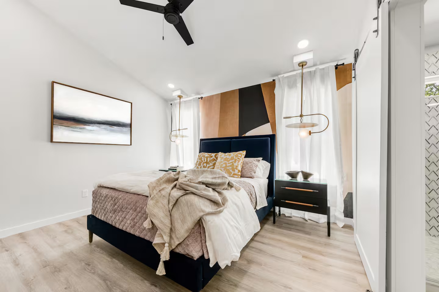 Modern bedroom with navy blue bed and gold accents