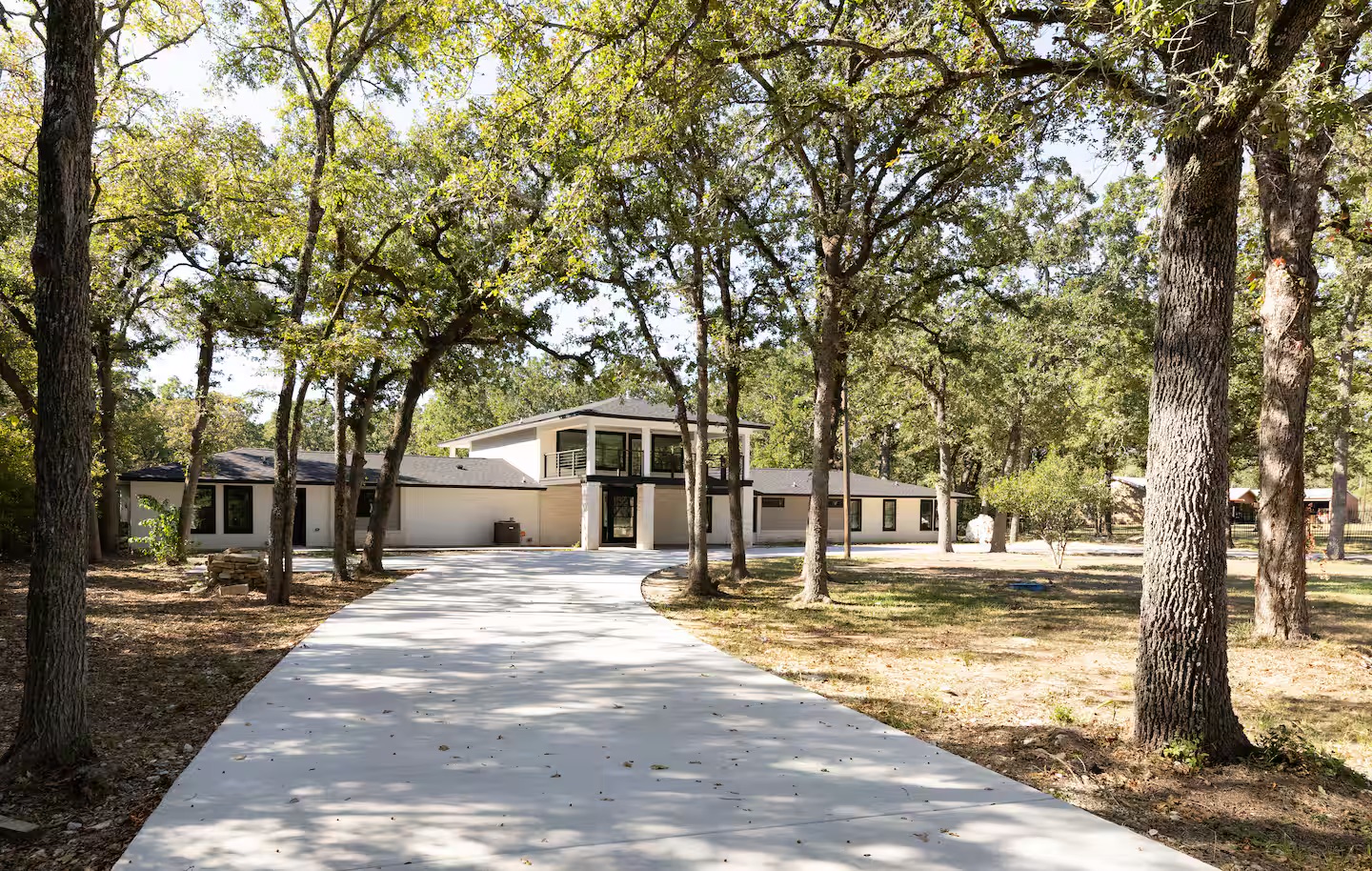 Tree-lined driveway approach to vacation home