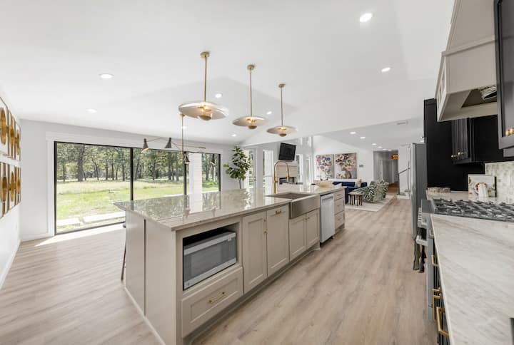 Kitchen dining area with bar seating and floor-to-ceiling windows