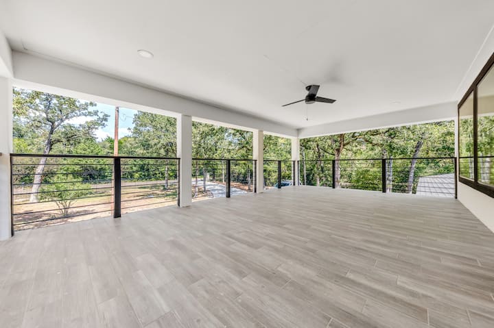 Spacious deck with railing and tree views