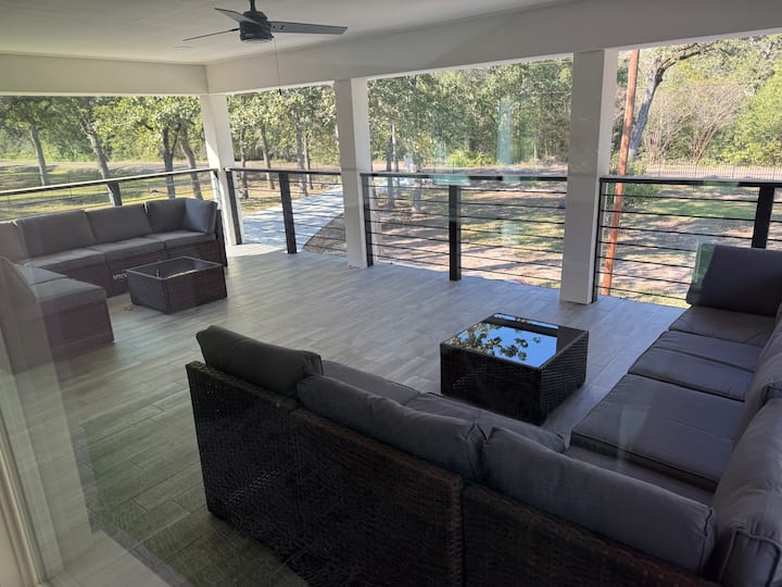 Outdoor lounge area with forest backdrop