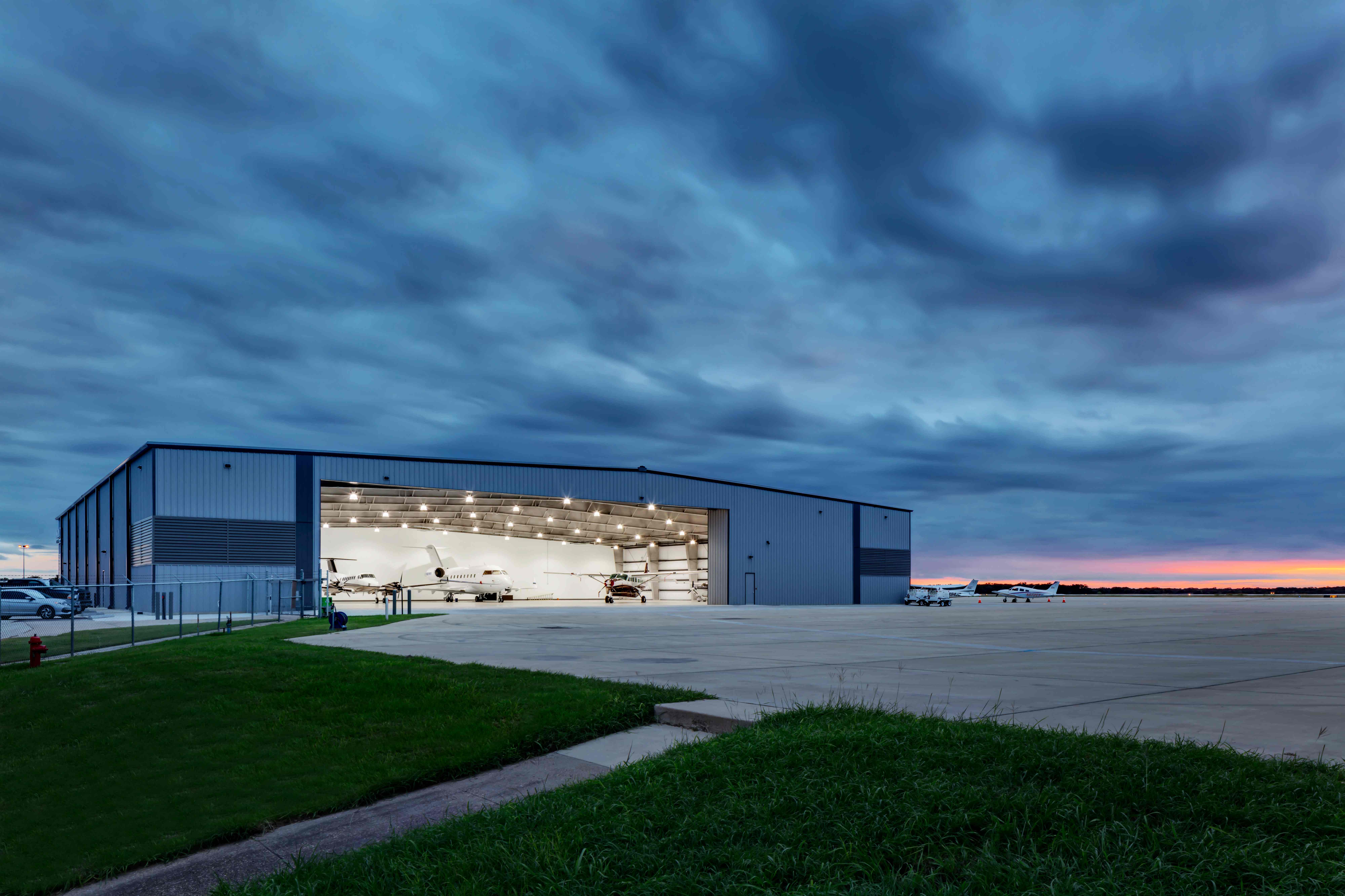 Private jet hangar at sunset